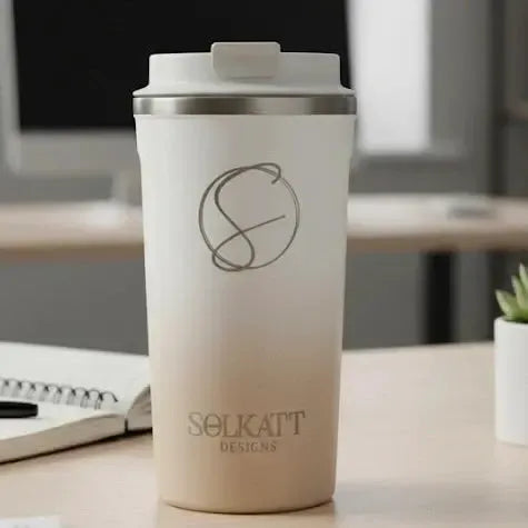 Pastel beige insulated travel mug on a desk — reusable stainless steel coffee cup for warm Australian days.