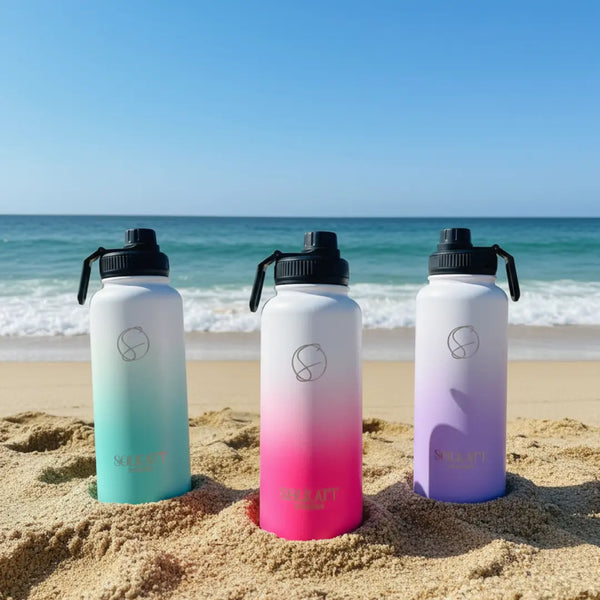 pink purple 1 litre drink bottles beach shot - Solkatt Designs