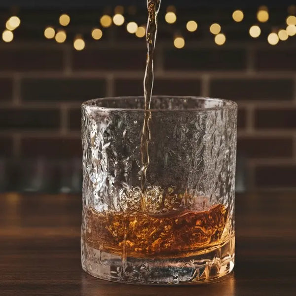 Old Fashion Whisky Glass with whiskey being poured, showing the smooth pour and amber color.