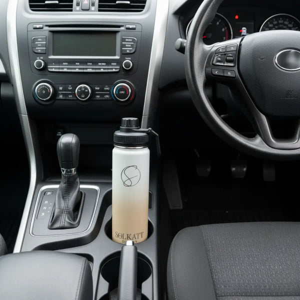 pastel beige 650ml drink bottle sitting in a car cupholder - Solkatt Designs