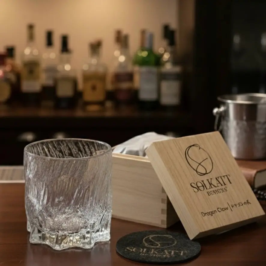 Dragon Claw whisky glass displayed with multiple wooden gift boxes for a collection view.