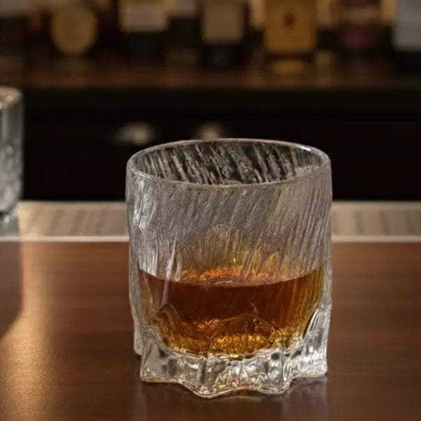 Dragon Claw whisky glass with bourbon being poured, capturing the liquid mid-stream.