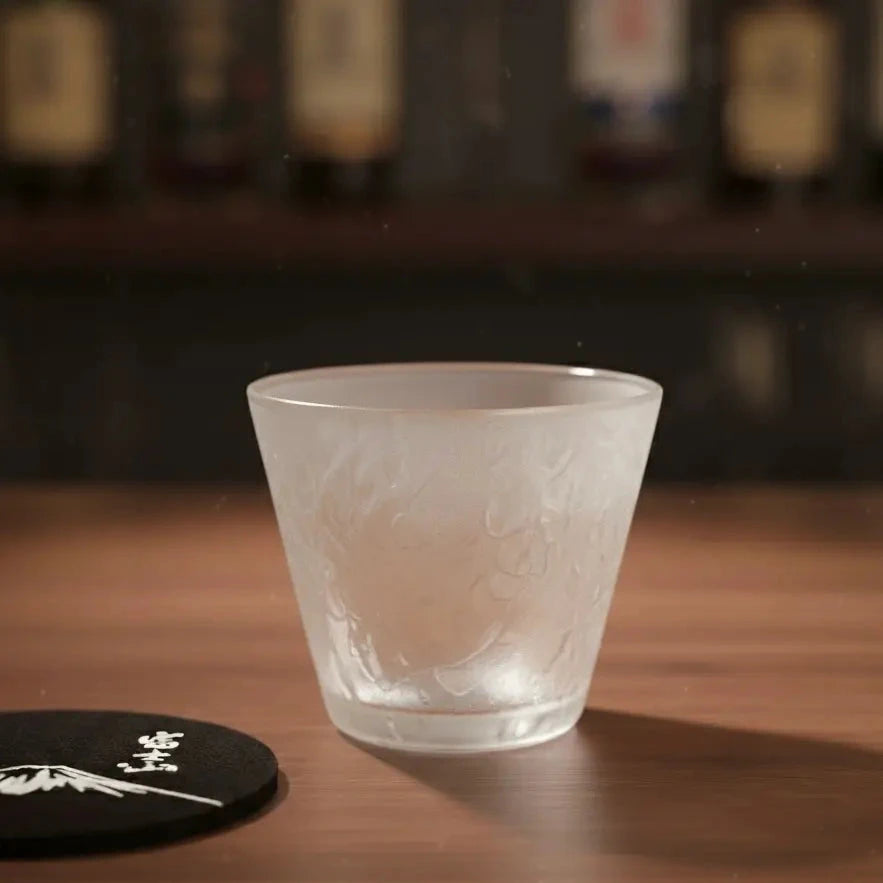 Hazy Snow Japanese Whisky Glass on a bar top, showing its frosted, hazy design.
