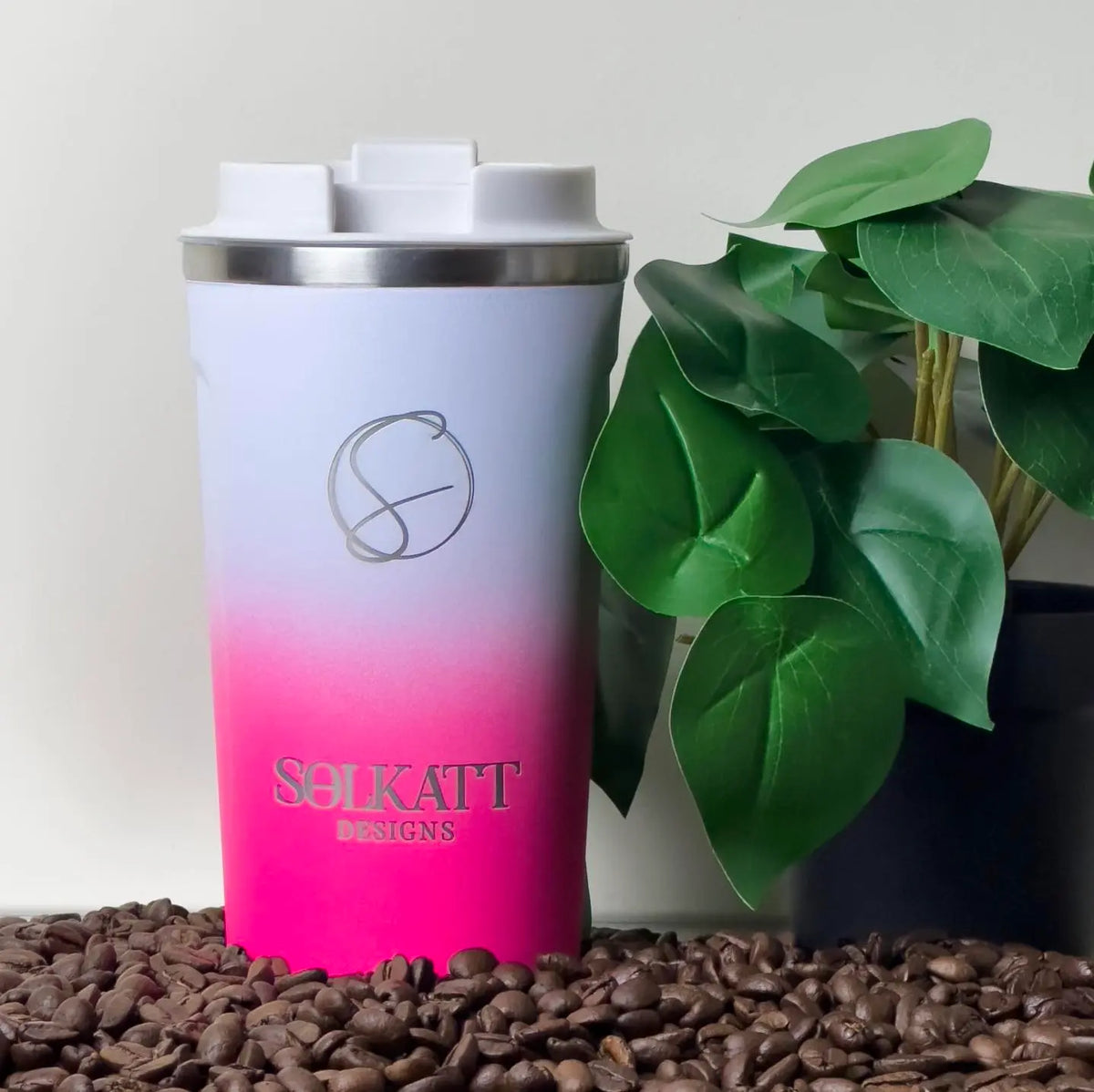 Hot Pink reusable coffee cup on coffee beans – stainless steel travel mug with lid – Solkatt Designs