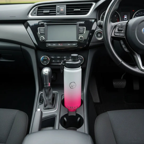 hot pink 650ml drink bottle sitting in a car cupholder - Solkatt Designs