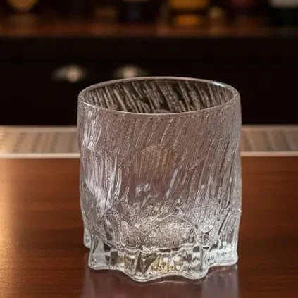 Empty Japanese Dragon Claw whisky glass placed on a polished bar surface.