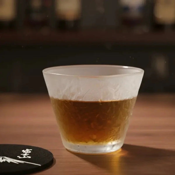 Hazy Snow Whisky Glass filled with golden Japanese whisky, showcasing the glow through the frosted texture.
