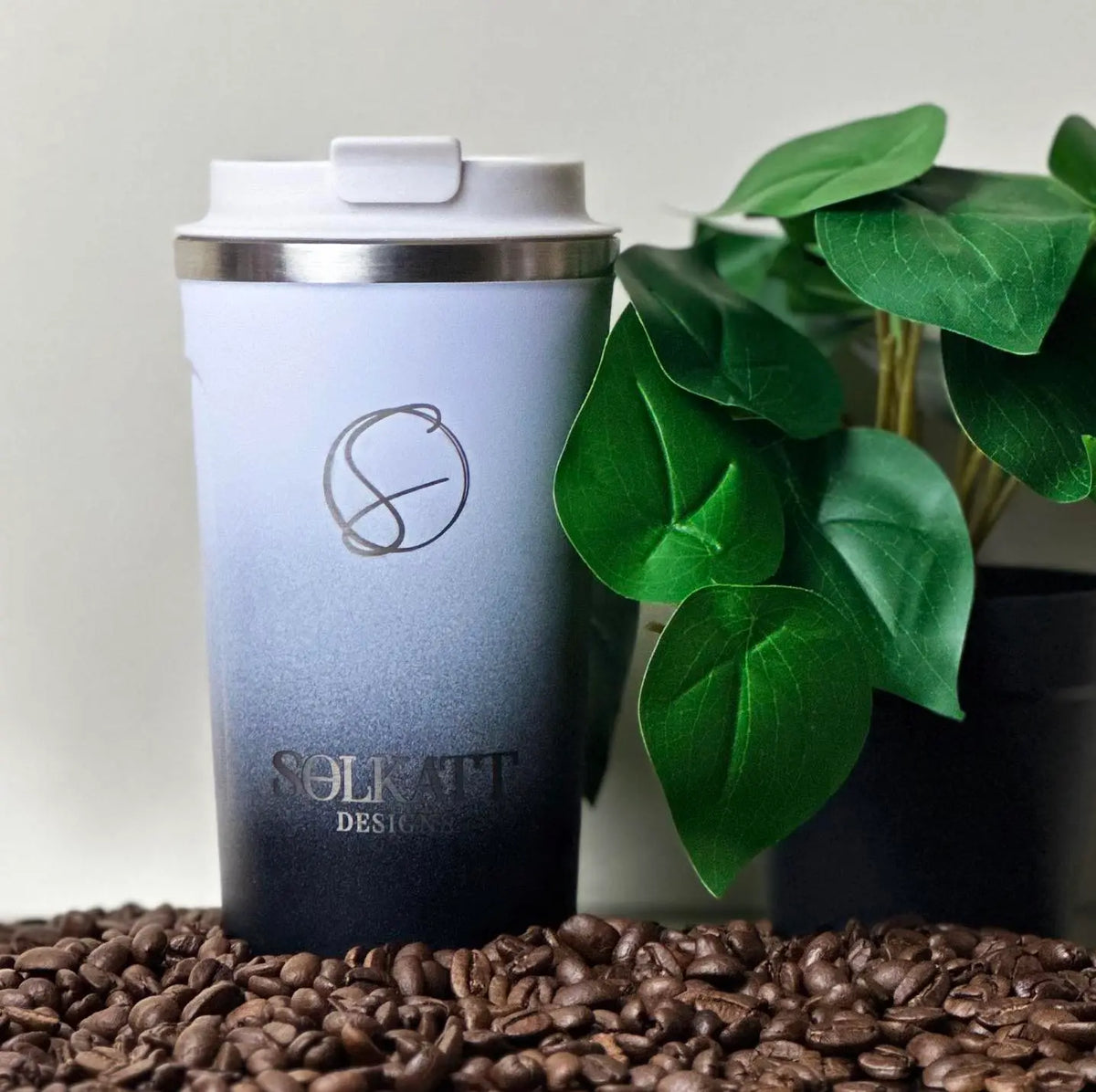 Midnight Black reusable coffee cup on coffee beans – stainless steel travel mug with lid – Solkatt Designs