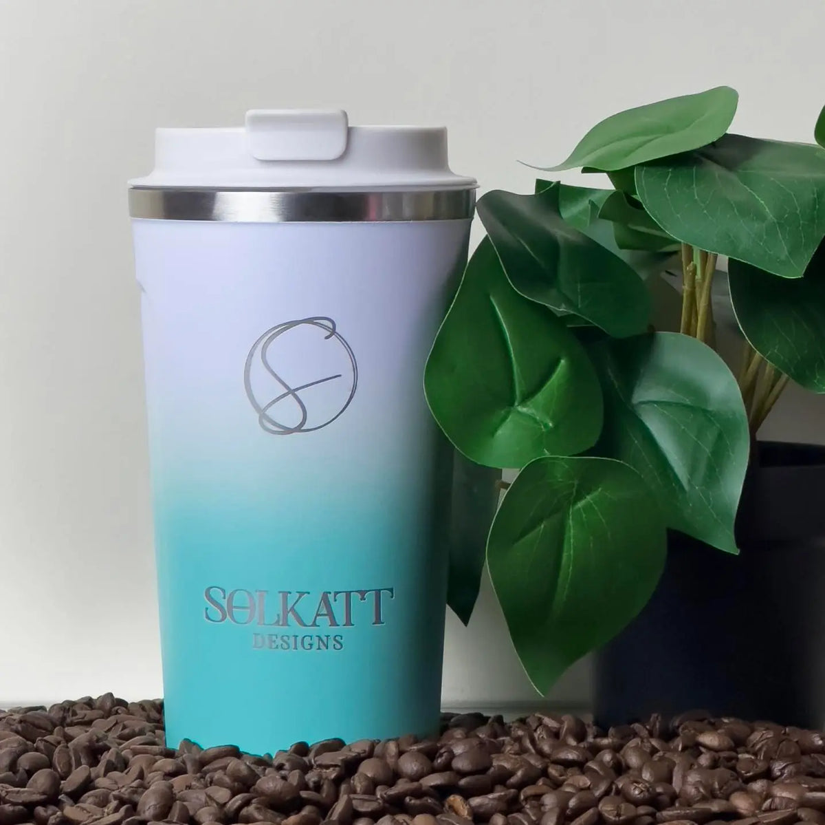 Ocean Aqua reusable coffee cup on coffee beans – stainless steel travel mug with lid – Solkatt Designs