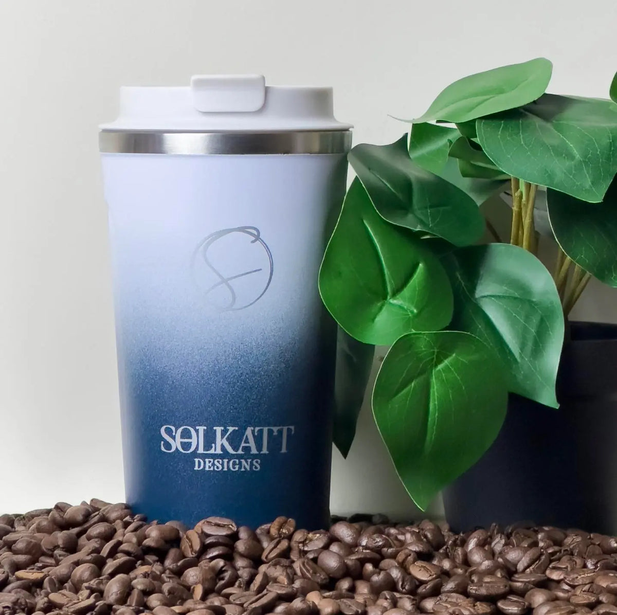 Royal Blue reusable coffee cup on coffee beans – stainless steel travel mug with lid – Solkatt Designs