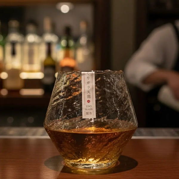 Snowflake whisky glass filled with golden bourbon, highlighting its frosted detailing.