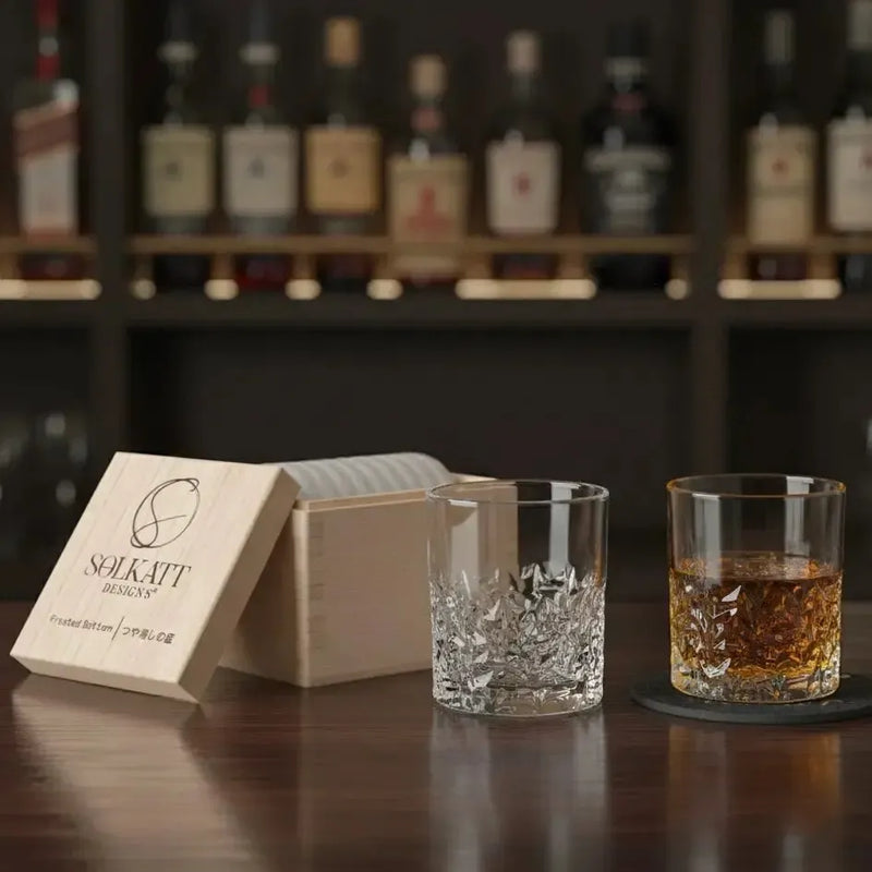 Frosted whisky tumbler placed on a wooden bar top, showcasing its wood gift box and ready to be filled with your favourite spirit.
