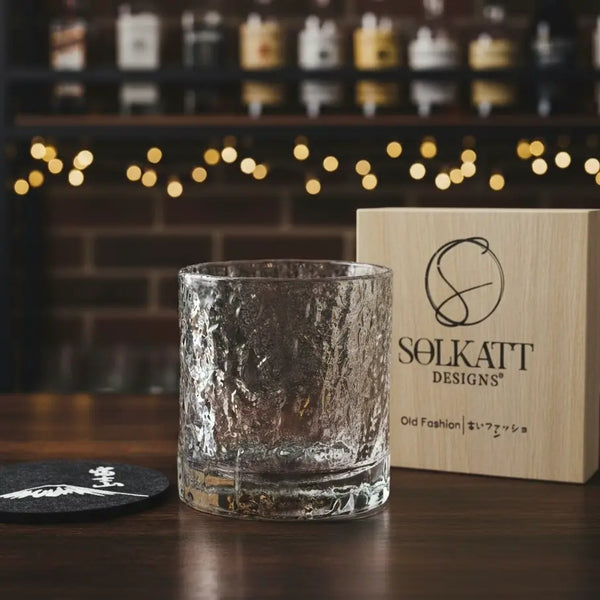 Whisky glass paired with a foam coaster and gift box, highlighting the complete gift set.