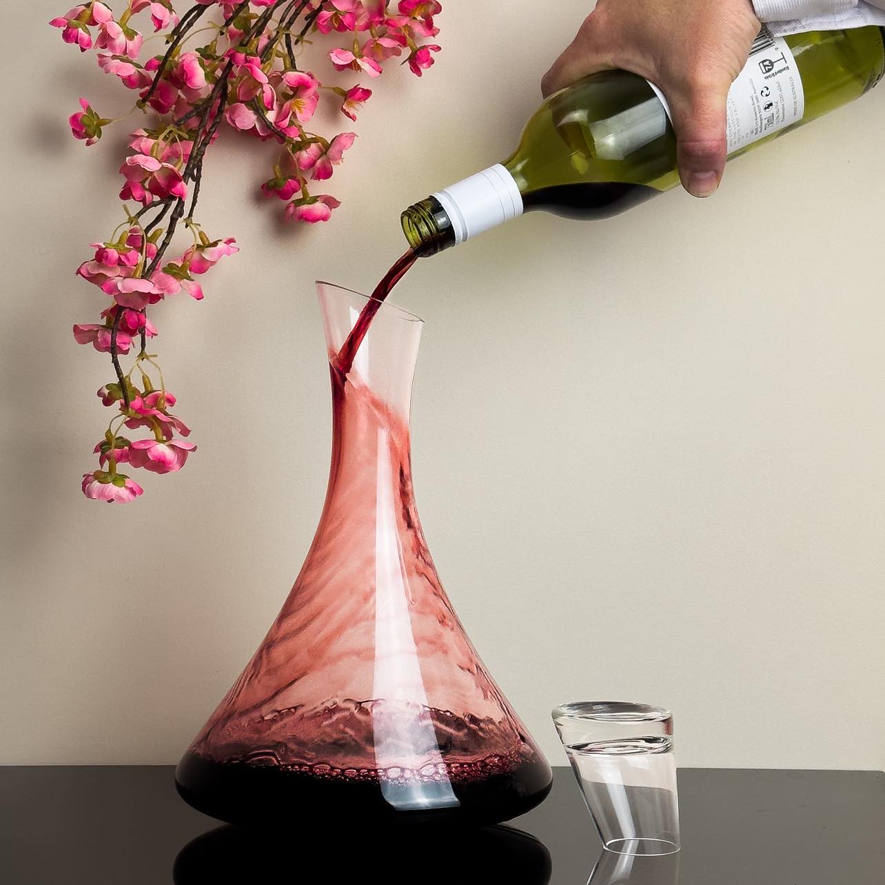 https://www.solkattdesigns.com/cdn/shop/products/The_Jett_Wine_Decanter_Hand_Blown_Glass_With_Glass_Lid_Pour-833756.jpg?v=1698625655&width=1445